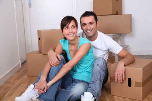 Professional movers carrying furniture through a townhouse in Kennington