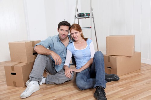 Professional movers loading household items into a removal van