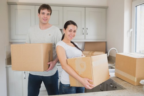 Professional movers handling furniture in a Kennington street